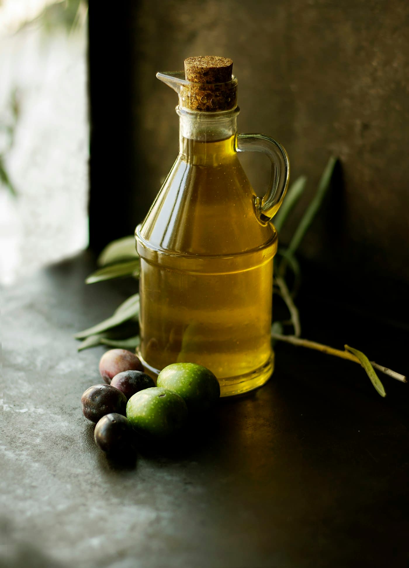 Glass bottles of oil on a wooden board